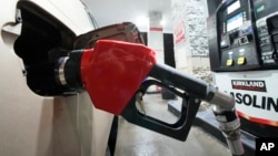 FILE - A car is fueled at a Costco Warehouse gas station in Cranberry, Pennsylvania, Jan. 23, 2023.