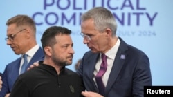 FILE - Ukrainian President Volodymyr Zelenskyy speaks to NATO Secretary-General Jens Stoltenberg before the first plenary session at the European Political Community meeting at Blenheim Palace in Woodstock, Britain, July 18, 2024.