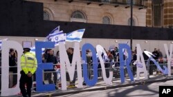 Protestors demand democracy during the visit of Israeli Prime Minister Benjamin Netanyahu to 10 Downing Street in London, March 24, 2023.