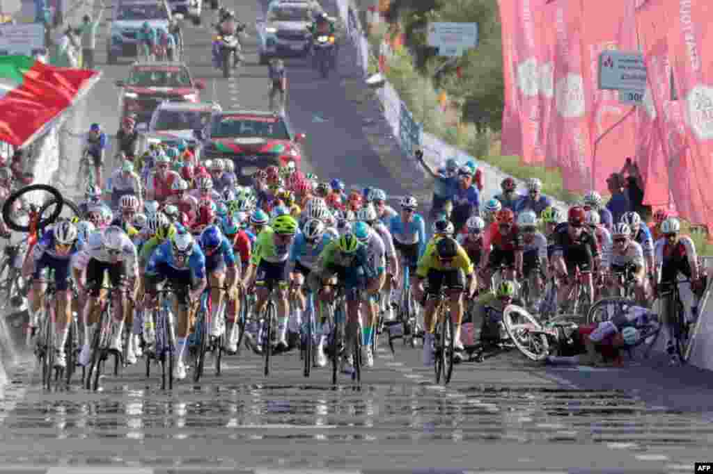 Riders crash before the finish line during stage 1 of the 6th UAE Tour 2024, from Al Dhafra Walk to Liwa.