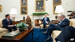 President Joe Biden speaks during a meeting with Congressional leaders in the Oval Office of the White House, in Washington, Feb. 27, 2024. From left, House Speaker Mike Johnson, Vice President Kamala Harris, Biden and Senate Majority Leader Chuck Schumer.