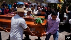 Pallbearers carry the casket of armed civilian defense leader Hipolito Mora during a funeral service for him and two of his bodyguards, in La Ruana, Mexico, July 1, 2023. 
