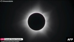 In this screengrab taken on April 20, 2023 from Timeanddate, Perth Observatory, and Learmonth Solar Observatory video footage via AFPTV, the moon blocks out the sun during a full solar eclipse in Western Australia's town of Exmouth.
