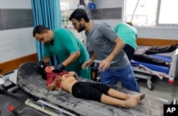 A wounded Palestinian wounded girl receives treatment at Kama Adwan hospital following Israeli bombardment on a UN school used as shelter, in Jabaliya, on the outskirts of Gaza City, Nov. 2, 2023.