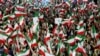 Supporters wave the national flag as they attend a campaign rally by Iranian ultraconservative former nuclear negotiator Saeed Jalili, two days before a presidential election runoff, in Tehran on July 3, 2024. 