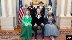 Clockwise from left, 2023 Kennedy Center Honorees Queen Latifah, Barry Gibb, Renee Fleming, Billy Crystal and Dionne Warwick pose for a photo at the State Department following the Kennedy Center Honors gala dinner, Dec. 2, 2023, in Washington.