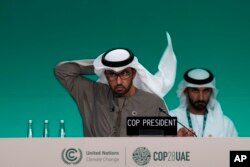 COP28 President Sultan al-Jaber adjusts his ghutra at a a plenary session at the COP28 U.N. Climate Summit, in Dubai, United Arab Emirates, Dec. 9, 2023.