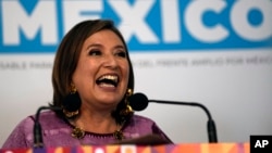 FILE - Senator Xochitl Galvez, an opposition presidential hopeful, speaks to the press after registering her name as a candidate in Mexico City, July 4, 2023.