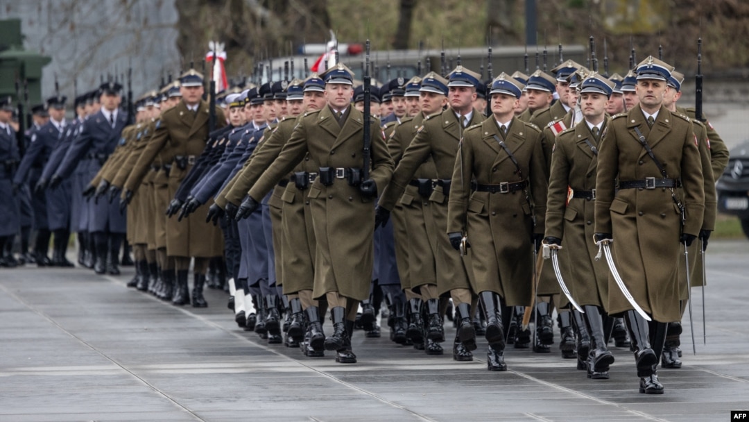 FILE - Soldiers are seen marching in a parade during a ceremony to mark the 25th anniversary of Poland joining NATO, on March 12, 2024 in Warsaw. 