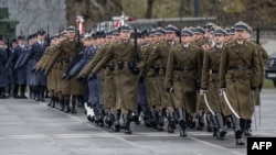 FILE - Soldiers are seen marching in a parade during a ceremony to mark the 25th anniversary of Poland joining NATO, on March 12, 2024 in Warsaw. 