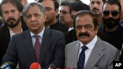 Pakistan's Interior Minister Rana Sanaullah, right, and Law Minister Azam Nazeer Tarar, left, speak to media outside the Supreme Court in Islamabad, Pakistan, on April 4, 2023, the day the court ordered snap elections in two provinces be held May 14. Tarar criticized the ruling.