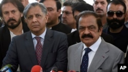 Pakistan's Interior Minister Rana Sanaullah, right, and Law Minister Azam Nazeer Tarar, left, speak to media outside the Supreme Court in Islamabad, Pakistan, on April 4, 2023, the day the court ordered snap elections in two provinces be held May 14. Tarar criticized the ruling.