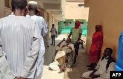 FILE - Patients wait at a hospital amid the spread of cholera and dengue fever cases, in Gedaref city, Sudan, Sept. 27, 2023.