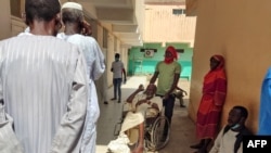 FILE - Patients wait at a hospital amid the spread of cholera and dengue fever cases, in Gedaref city, Sudan, Sept. 27, 2023.