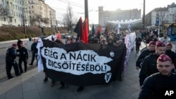 Antifascist activists march in Hungary's capital on Saturday to oppose an annual commemoration held by far-right groups, in Budapest, Feb. 10, 2024. The banner reads: "Stop the glorification of Nazis."