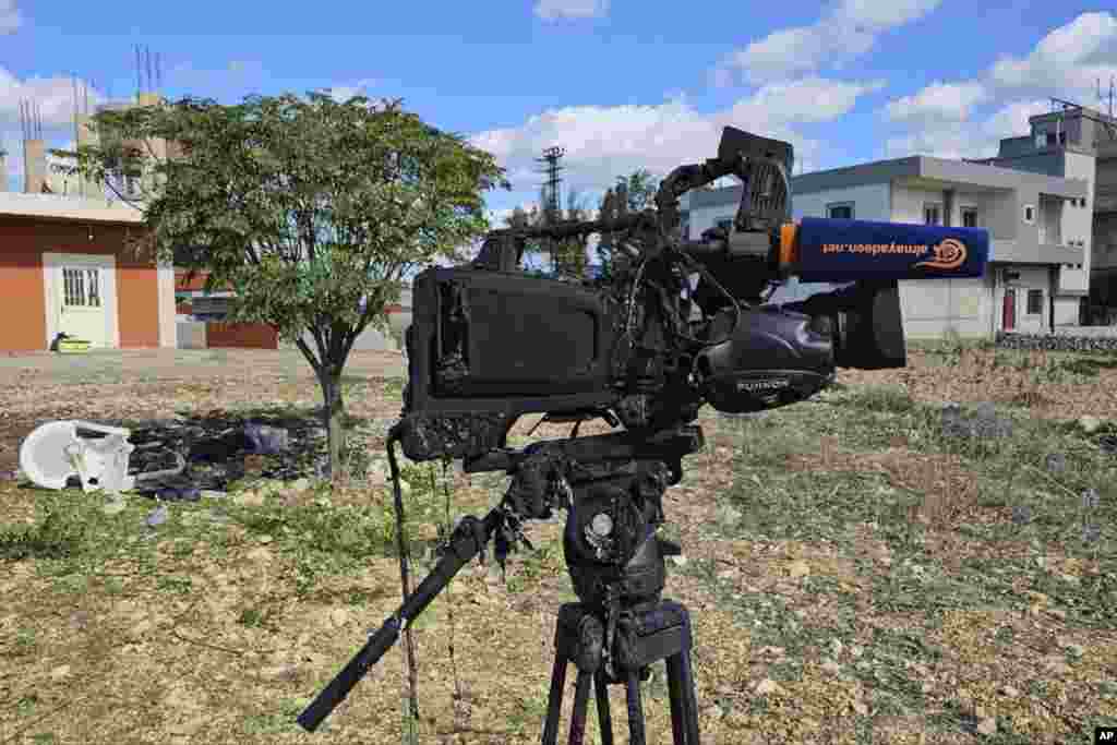 The damaged camera of Pan-Arab TV network Al-Mayadeen cameraman Rabih Maamari, who was killed in an Israeli strike, is seen at the Lebanese border village of Tair Harfa near the border with Israel.