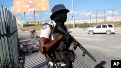 FILE - A National Police officer patrols an intersection in Port-au-Prince, Haiti, Jan. 26, 2024. After multiple delays and court challenges, it appears that the deployment of Kenyan police officers to Haiti may be set for June 25, according to reports. 