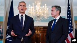 Secretary of State Antony Blinken, right, looks to NATO Secretary General Jens Stoltenberg as the speaks at the State Department in Washington, June 13, 2023.