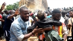 A student is rescued from the rubble of a collapsed two-story building in Jos, Nigeria, July, 12, 2024.