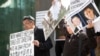 FILE - Uyghur activists protest China's treatment of Uyghurs, in Vancouver, Canada, on May 8, 2019. 