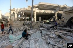 Palestinians inspect the damage of a destroyed mosque following an Israeli airstrike in Khan Younis refugee camp, southern Gaza Strip, Nov. 8, 2023.