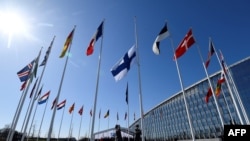 Финские военные поднимают флаг Финляндии, 31-й по счету страны в составе Североатлантического альянса, у здания штаб-квартиры НАТО в Брюсселе. 4 апреля 2023 г. (архивное фото) 