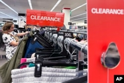 A shopper looks at clothes at a retail store in Northbrook, Illinois, May 13, 2024. 