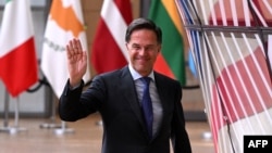 FILE - Outgoing Netherland's Prime Minister Mark Rutte waves as he arrives for the European Council Summit at the EU headquarters in Brussels, June 27, 2024. 