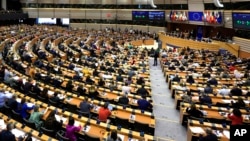 Members of European Parliament participate in a series of votes as they attend a plenary session at the European Parliament in Brussels, April 10, 2024.