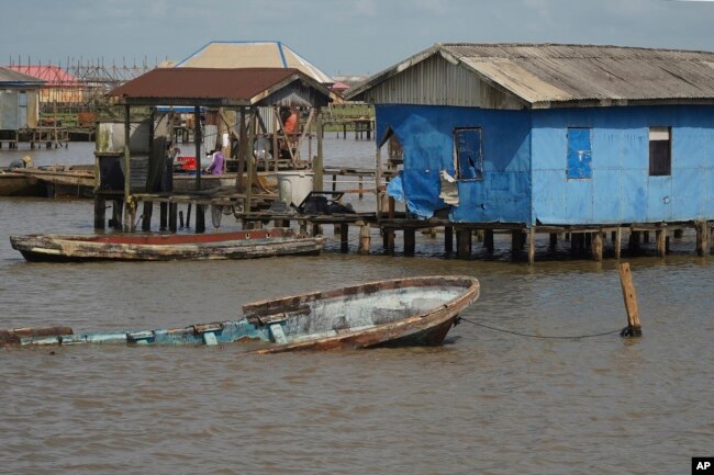 A partially submerged boat is seen at the coastal area of Ayetoro, in Southwest Nigeria, Thursday, April 4, 2024. (AP Photo/Dan Ikpoyi)