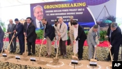 Pakistan's Prime Minister Shehbaz Sharif, center, with unidentified Chinese officials dig during the groundbreaking ceremony of the Chashma-5 nuclear power plant in Chashma, Mianwali, Pakistan, July 14, 2023, in this photo released by Press Information Department.