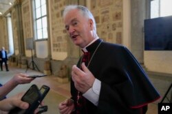 FILE - Bishop Paul Tighe, secretary of the Pontifical Council for Culture, talks to reporters at the Vatican, June 23, 2023.