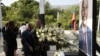 Haiti's Prime Minister Ariel Henry places flowers before a photo of slain Haitian President Jovenel Moise, during a ceremony in memory Moise two years after his killing, at the National Pantheon Museum in Port-au-Prince, Haiti, July 7, 2023.