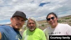 Three generations of Navajo silver artisans. Left to Right, Reggie Mitchell, father Eugene Mitchell and son Bronson Mitchell of Gallup, New Mexico.