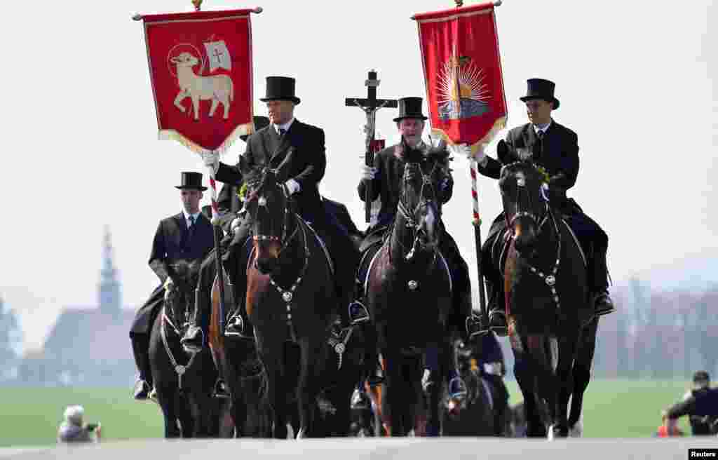 Men of Slavic ethnic minority of Sorbs dressed in black tailcoats, ride decorated horses during an Easter rider procession near Panschwitz, Germany.
