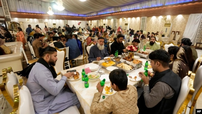 Guests eat a wedding reception at Radiance banquet hall in Karachi, Pakistan, Jan. 27, 2024.