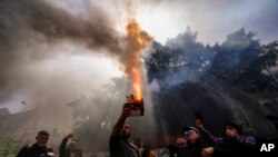 A protester launches fireworks at the Lebanese Central Bank building as frustrated depositors rally against Central Bank Gov. Riad Salameh, who is facing corruption charges, and the deepening financial crisis in Beirut, Lebanon.