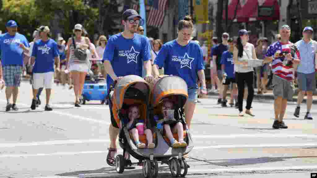 People participate in a community walk in Highland Park, Ill., on July 4, 2023, a year after a shooter killed seven people at the city's annual parade. The walk replaced the parade, and the city also held a remembrance service. 