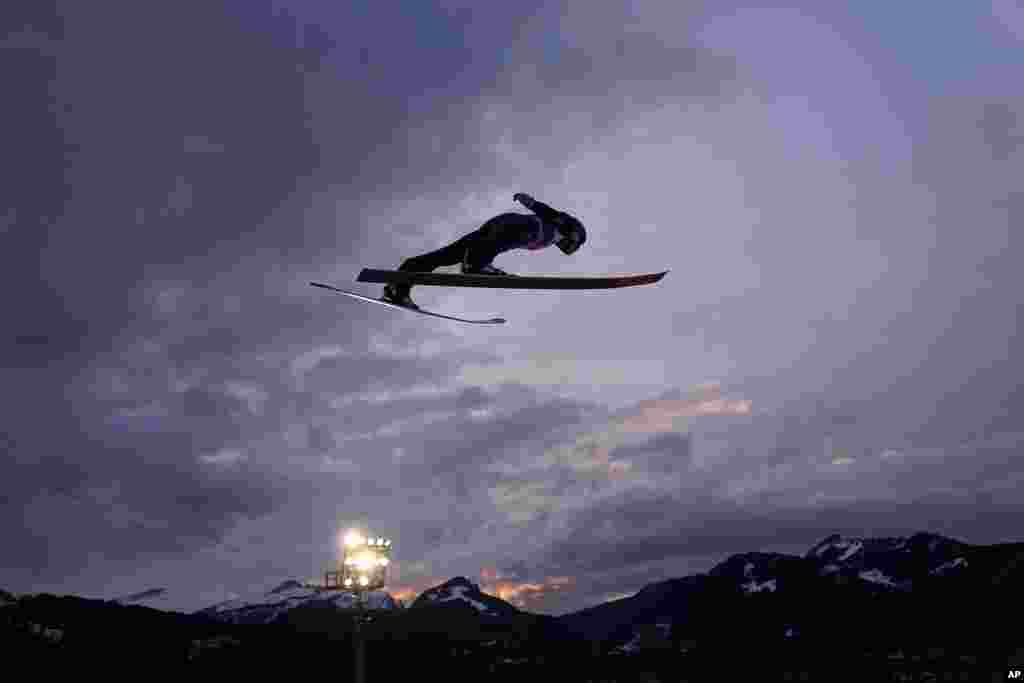 Andreas Wellinger, of Germany, flies through the air during his trial jump at the first stage of the 72th Four Hills ski jumping tournament in Oberstdorf, Germany.