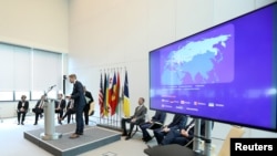 FILE - A screen is pictured at the news conference to announce a major law enforcement action against a transnational organized cybercrime at the Europol's headquarters in The Hague, Netherlands, May 16, 2019.