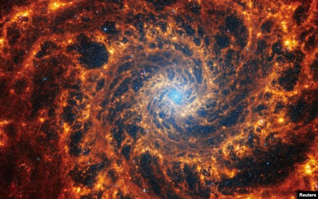 Spiral galaxy NGC 628, located 32 million light-years away from Earth, is seen in an undated image from the James Webb Space Telescope. (NASA, ESA, CSA, STScI, Janice Lee (STScI), Thomas Williams (Oxford), and the PHANGS team/Handout via REUTERS)