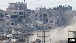 A picture taken in southern Israel near the border with the Gaza Strip on December 24, 2023, shows an Israeli army tank driving inside the Palestinian enclave amid continuing battles between Israel and the militant group Hamas.