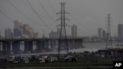 FILE - High-tension power lines pass through Makoko slum in Lagos, Nigeria, Aug. 20, 2022.