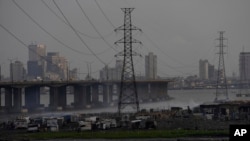 FILE - High-tension power lines pass through Makoko slum in Lagos, Nigeria, Aug. 20, 2022.