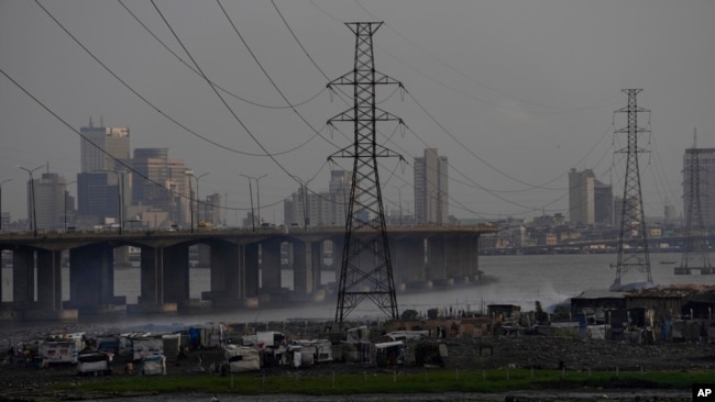 FILE - High-tension power lines pass through Makoko slum in Lagos, Nigeria, Aug. 20, 2022.
