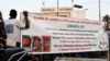 FILE - Supporters of the Alliance of Sahel States (AES) hold up a banner as they celebrate Mali, Burkina Faso and Niger leaving the Economic Community of West African States (ECOWAS), in Niamey, Niger, Jan. 28, 2024. 