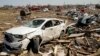A vehicle awaits removal, March 25, 2023, after getting destroyed by a Friday night tornado that hit Rolling Fork, Miss. 