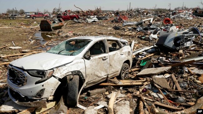 A vehicle awaits removal, March 25, 2023, after getting destroyed by a Friday night tornado that hit Rolling Fork, Miss.