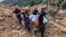 Rescuers carry a body they recovered at the landslide-hit village of Masara in Davao de Oro province, southern Philippines, Feb. 9, 2024. (Municipality of Monkayo via AP)