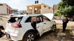 Palestinians inspect a car targeted by Israeli forces during a raid where they killed a Palestinian militant, near Tubas, in the Israeli-occupied West Bank April 12, 2024. 